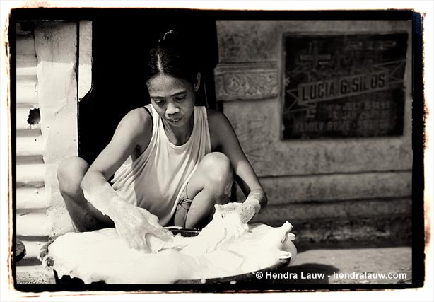 Washing clothes at the Manila North Cemetery