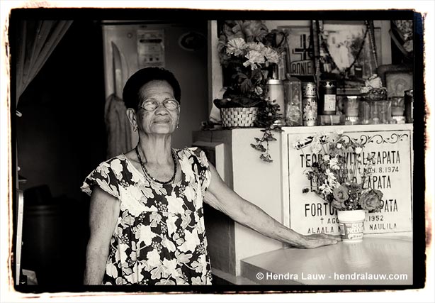 A woman inside her 'house' at the Manila North Cemetery