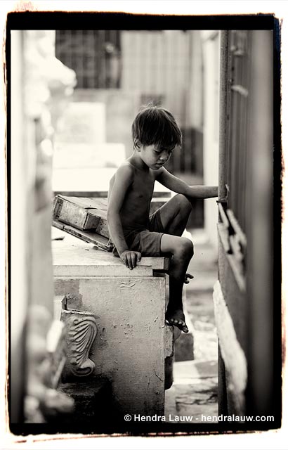 A boy playing alone at the Manila North Cemetery