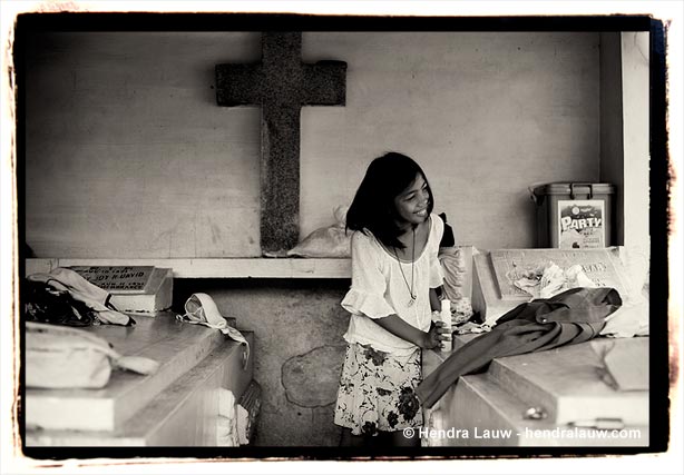 Folding clothes at the Manila North Cemetery