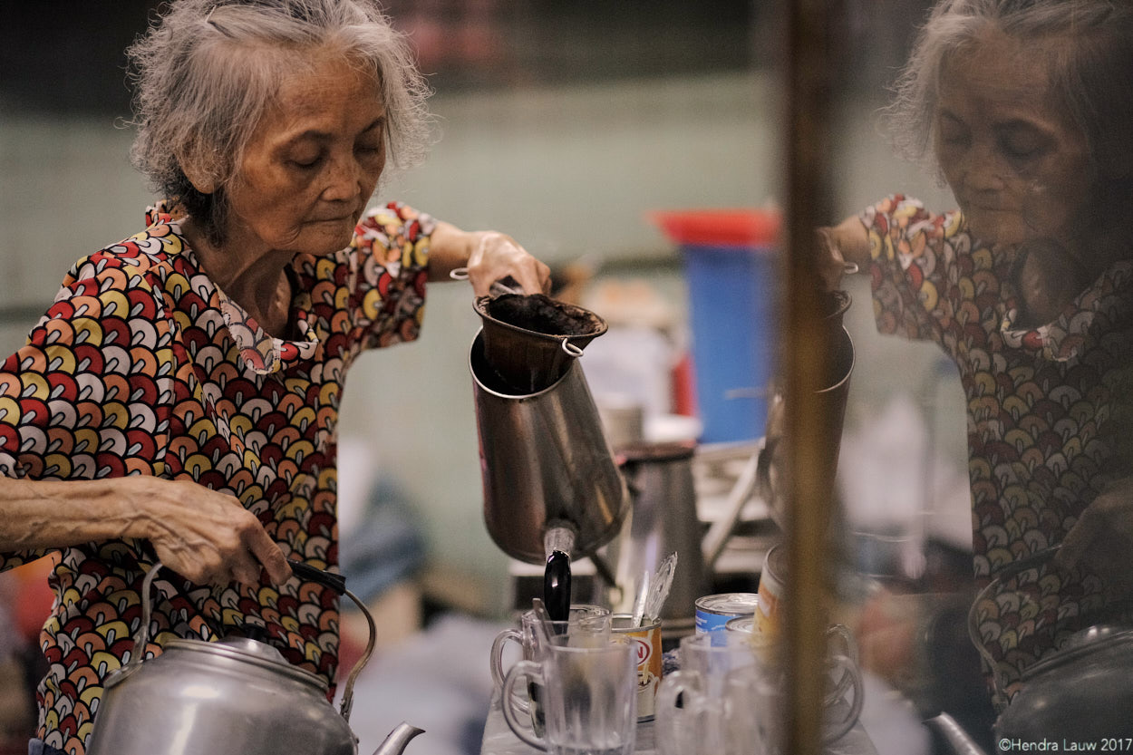 An old lady making coffee at Hup Lee Coffee Shop in Jalan Besar Singapore